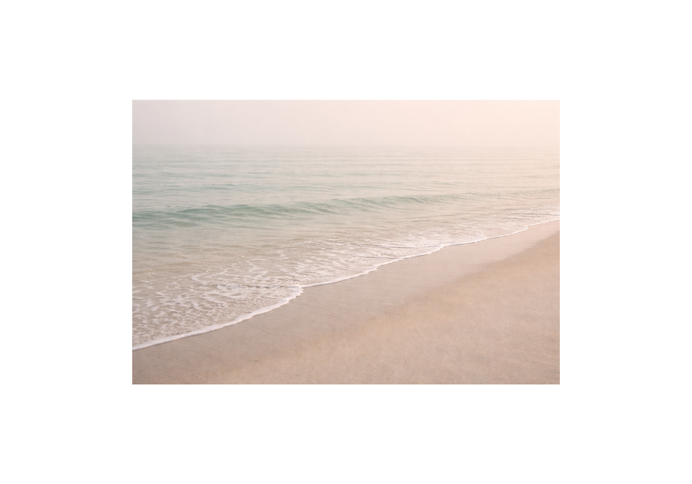 Calm beach shoreline in Victoria BC with gentle morning waves and soft natural light (grief counselling Victoria BC blog image)